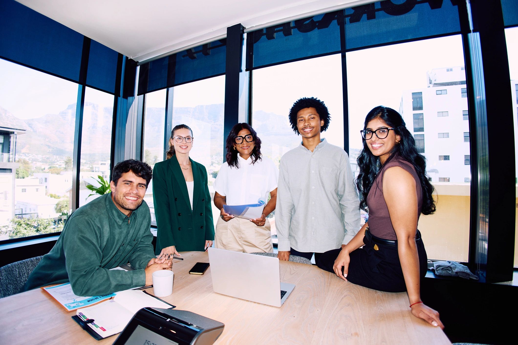 Executive team standing in modern office